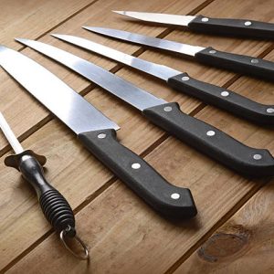 set of kitchen knives on a wooden table
